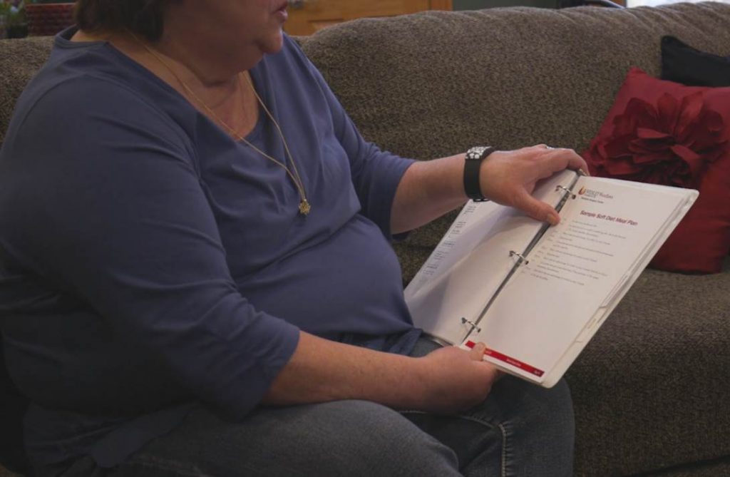 Pam looking at a notebook